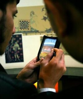 smart phone being used to research information in a museum