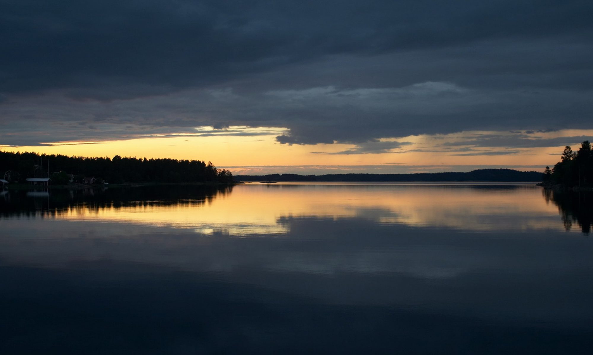 Scenic sunset reflected in mirror still water.